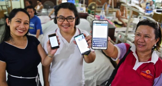 LEARNS App on mobile phones Image of three women presenting LEARNS App on their mobile phones